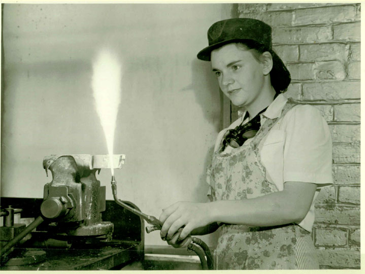 A young female worker practices her brazing technique