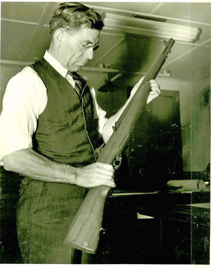 John Cantius Garand Inspecting the Rifle he designed