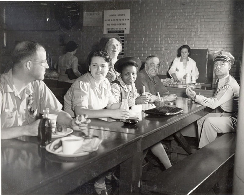 A jolly group of workers eating lunches together